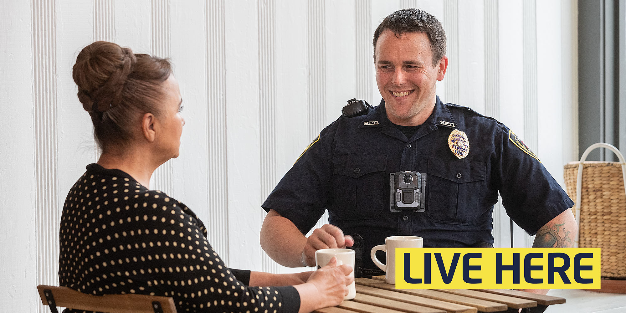 live here: police officer shares coffee with a citizen in a coffee shop