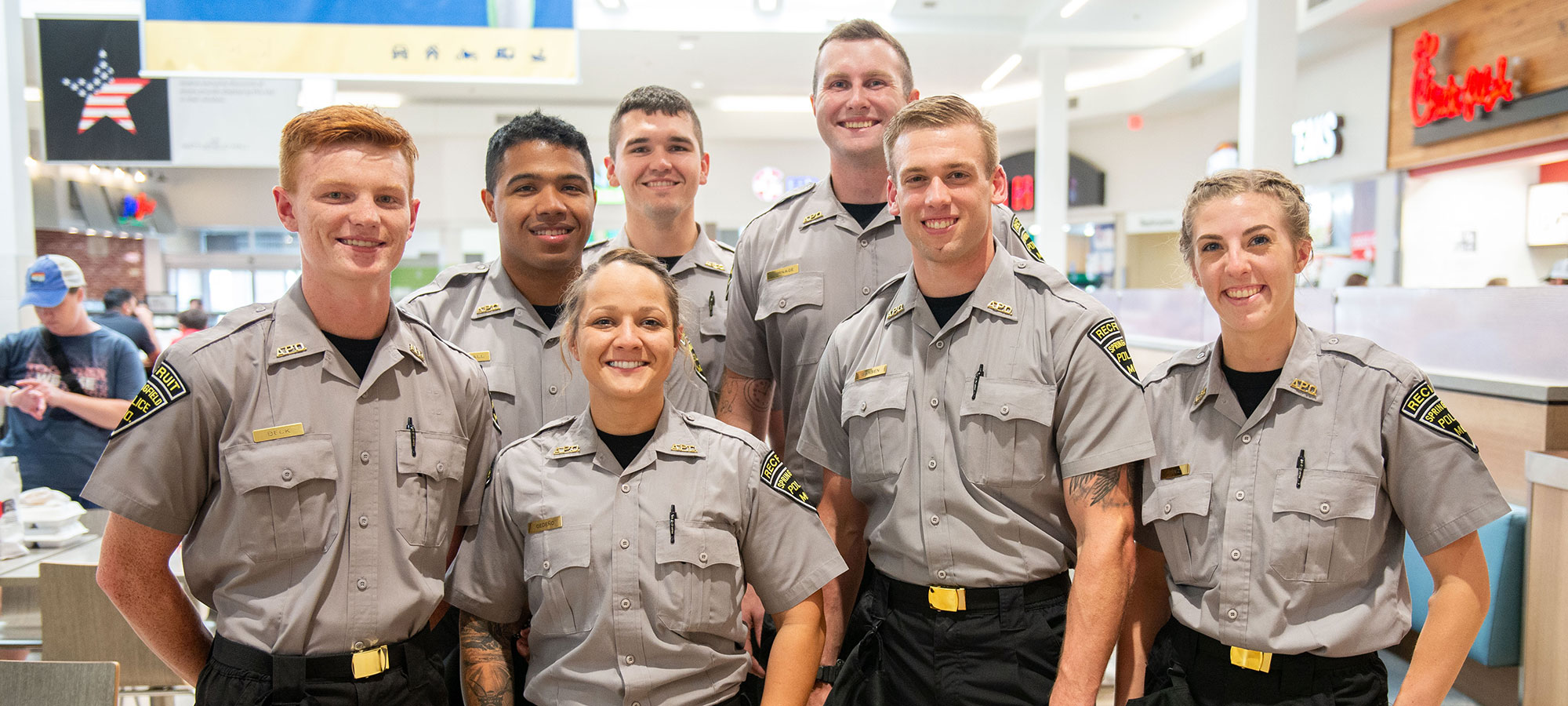 group of new police recruits in an indoor food court